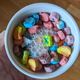 A small, but still too large portion of Lucky Charms Just Magical Marshmallows in milk